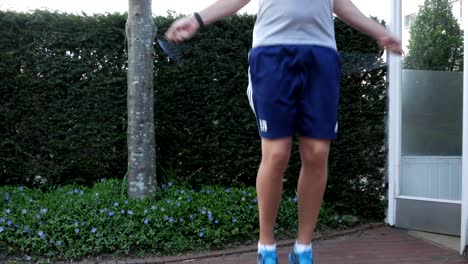 Fit-male-man-jumping-rope-outdoor-in-garden-due-worldwide-corona-pandemic