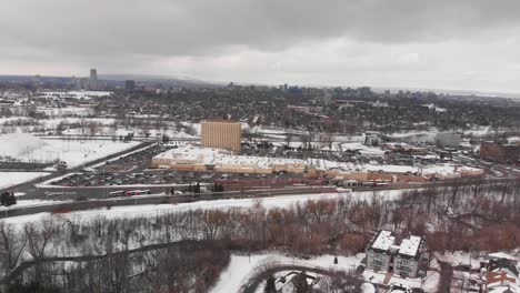 Aerial-drone-view-of-bus-station-in-Barrhaven-Ottawa-Ontario-Canada-in-winter-on-grey-day