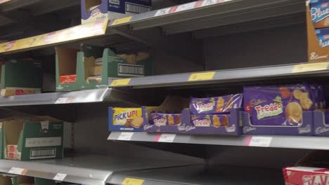 Restricted-supermarket-corona-virus-panic-buying-shoppers-store-shelves-biscuit-aisle