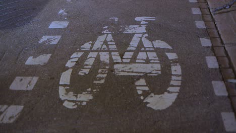 Closeup-Of-A-Bicycle-Lane-In-Toronto,-Shadows-Of-Moving-Cars
