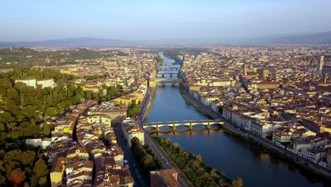 Arno-River-and-bridges-like-Ponte-Vecchio-in-the-city-of-Florence-Italy,-Aerial-pedestal-lift-shot