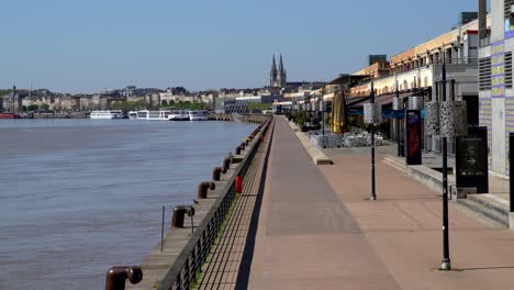 Garonne-river-north-shore-closed-restaurants-and-boardwalk-during-the-COVID-19-pandemic,-Stable-handheld-shot