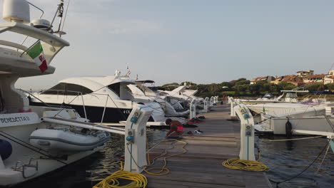 A-boy-works-at-the-moorings-with-luxury-boats-at-the-marina