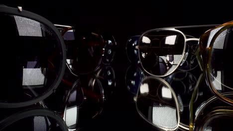 macro-view-flying-past-luxury-sunglass-brands-on-black-reflective-glass,-probe-lens-4k