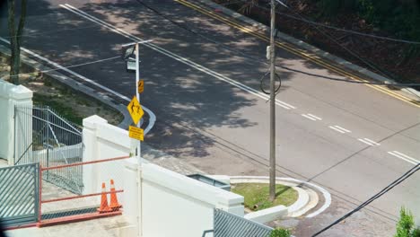Isometric-view-of-cars-passing-by-on-road-in-Malaysia,-telephoto-view