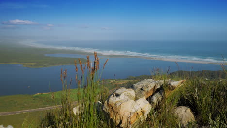 Panoramic-view-from-vantage-point-on-mountain-of-lagoon-and-pristine-coastline-with-white-beach,-Hermanus,-South-Africa