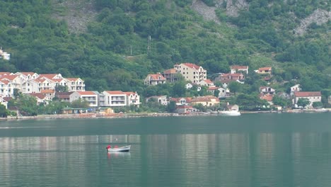 Fisherman-boat-sailing-across-the-Boka-Kotorska-Bay,-Adriatic-sea