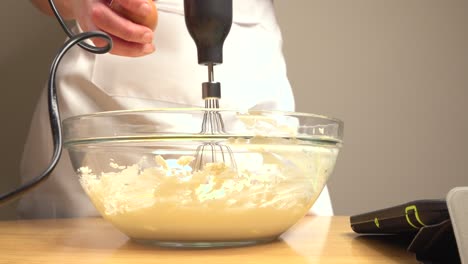 Adding-egg-to-bowl-with-cake-mix-and-whisk