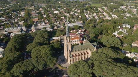 Aerial-orbit-shot-of-San-Isidro-Cathedral-surrounded-by-residential-neighborhood-near-Buenos-Aires-city