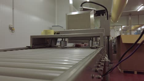 A-shot-of-burger-trays-coming-to-the-camera-from-a-conveyor-table