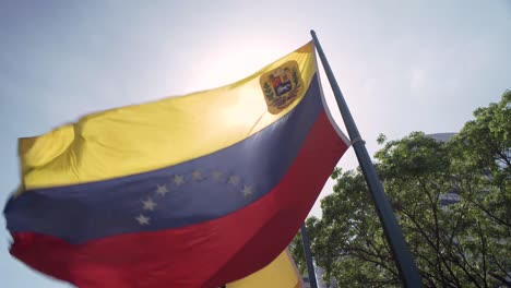 Venezuelan-flag-waving-in-Francia-Square,-also-known-as-Altamira-Square,-in-Chacao,-Caracas,-Venezuela