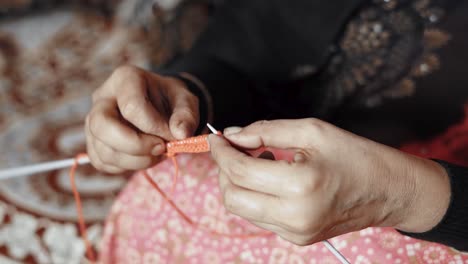 Woman's-hands-knitting-with-craft-needles-and-red-wool