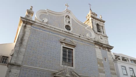 Small-town-church-facade-with-tiles-on-a-sunny-day,-Seixal---Portugal