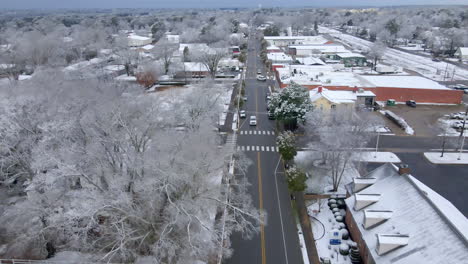 Drone-shot-of-small-town-main-street-USA-after-snowfall