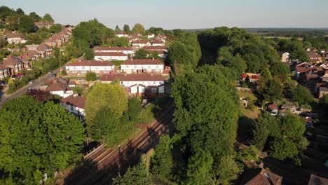 Drone-descending-towards-the-railway-in-Earlswood,-Redhill