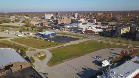 Aerial-of-WWII-museum-ship-and-surrounding-urban-area-in-Muskegon,-MI