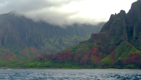 HD-120fps-Hawaii-Kauai-Boating-on-the-ocean-pan-right-to-left-of-mountains-and-green-cloudy-valley-with-boat-spray-in-foreground