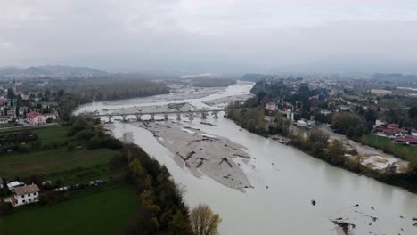 Aerial-shot-showing-Bridge-on-Piave-River-in-Veneto,-Italy-during-cloudy-day