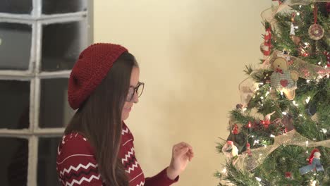 Woman-with-glasses-at-christmas.-Woman-decoratin-tree