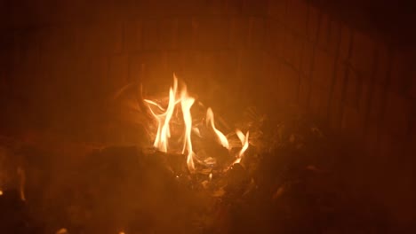 Slow-motion-footage-of-fire-burning-trash-in-a-fire-pit