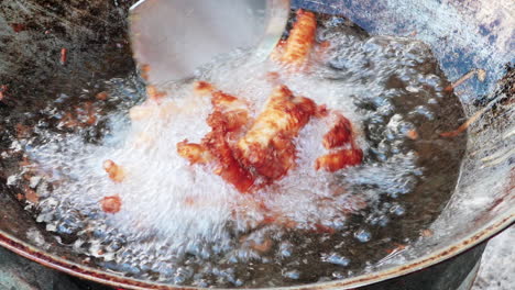 Extreme-close-up-of-deep-fried-chicken-feet-on-hot-oil---Thailand-dish