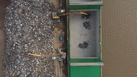 Aerial-birdseye-of-scrap-metal-being-loaded-onto-a-ship-to-be-sent-for-recycling