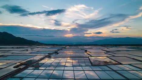 Aerial-hyper-lapse-showing-moving-clouds-over-salt-fields-during-golden-hour