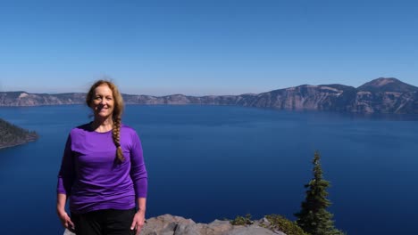 A-retired-senior-woman-smiles-on-the-edge-of-Crater-Lake-National-Park