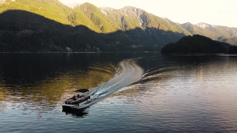 Aerial-drone-shot-of-boat-in-Indian-Arm,-an-inlet-ocean-in-British-Columbia,-Canada