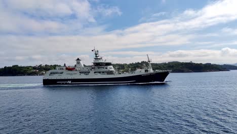 Huge-slaughter-factory-and-live-salmon-transportation-vessel-Norwegian-Gannet-saling-through-Norwegian-fjord---Hav-Line-company