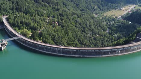 Aerial-orbit-hyperlapse-shot-of-a-dam-creating-a-beautiful-turquoise-lake-Paltinu-of-Doftana-Valley-in-Romania