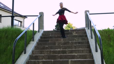 Beautiful-dancer-gracefully-climbs-down-the-stairs-in-the-park
