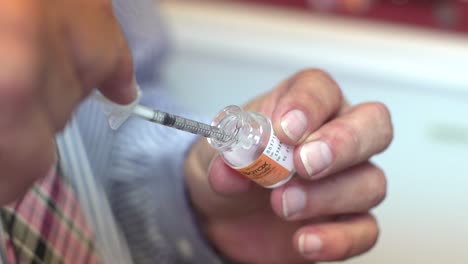 Dermatologist-Filling-Syringe-With-Botulinum-Toxin-From-Vial-For-Botox-Procedure-At-The-Clinic