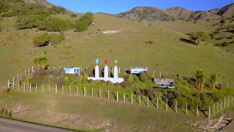 Information-signboards-and-artistic-installation-of-Maori-Masks-welcome-visitors-to-the-Port-Levy-area-of-New-Zealand