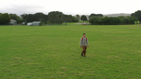 A-man-walking-across-the-sheep-park