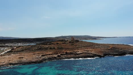 Luftaufnahme-Des-Korallenstrandes-In-Richtung-White-Tower-In-Der-Bucht-Von-Mellieha-Armier,-Malta