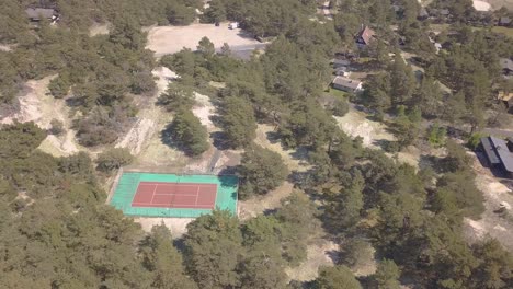 A-deserted-tennis-court-in-the-pine-sand-woods-next-to-the-ocean
