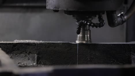 industrial-safety-first-concept,-casting-foundry,-CNC-machine-drilling-holes-with-carbide-drill-and-coolant-being-used