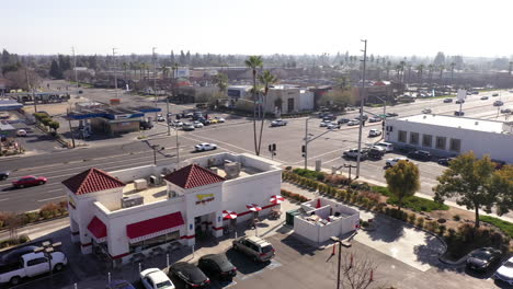 In-N-Out-Burger-restaurant-in-Visalia,-California,-aerial-orbit
