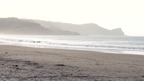 South-Popoyo-Beach-Nicaragua-with-ocean-waves-at-dusk,-Handheld-wide-shot