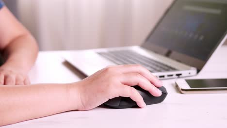 Businesswoman-hand-using-mouse-working-on-notebook-Technology-and-business-concept
