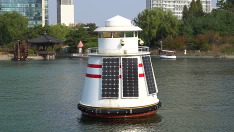 Ocean-water-quality-measurement-buoy-with-solar-panels-on-a-lake-in-Songdo-Central-Park,-Incheon-South-Korea