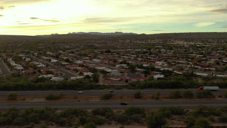 Nogales-highway-going-through-town-of-Green-Valley,-Arizona,-aerial-shot-at-sunrise