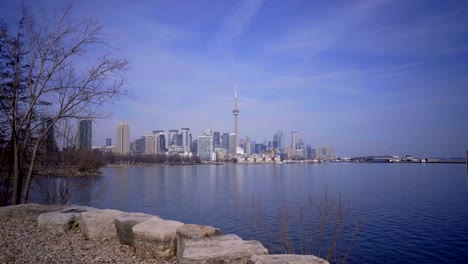 Beautiful-landscape-establishing-shot-of-Toronto,-Ontario,-Canada-skyline-from-Trillium-Park,-Ontario-provincial-park-developed-along-Lake-Ontario-noon