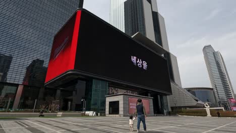 Coex-Artium-and-World-Trade-Center-complex-in-Seoul,-South-Korea-with-a-huge-advertisement-curved-display-at-the-entrance---wide-shot
