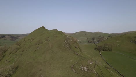 4K-drone-footage-of-a-big,-green,-beautiful-hill-in-the-Peak-District