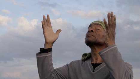 man-praying-to-god-Caribbean-man-praying-with-blue-sky-in-the-background-stock-video