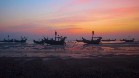 Traditional-fishing-boats-at-low-tide-under-St-Martin's-island-colorful-sunset---Bangladesh