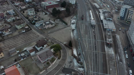 Aerial-of-large-trainyard-near-city-in-winter