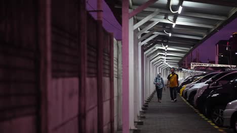 Yogyakarta,-Indonesia---Jan-21,-2022-:-a-young-couple-walking-in-a-lonely-corridor-at-night